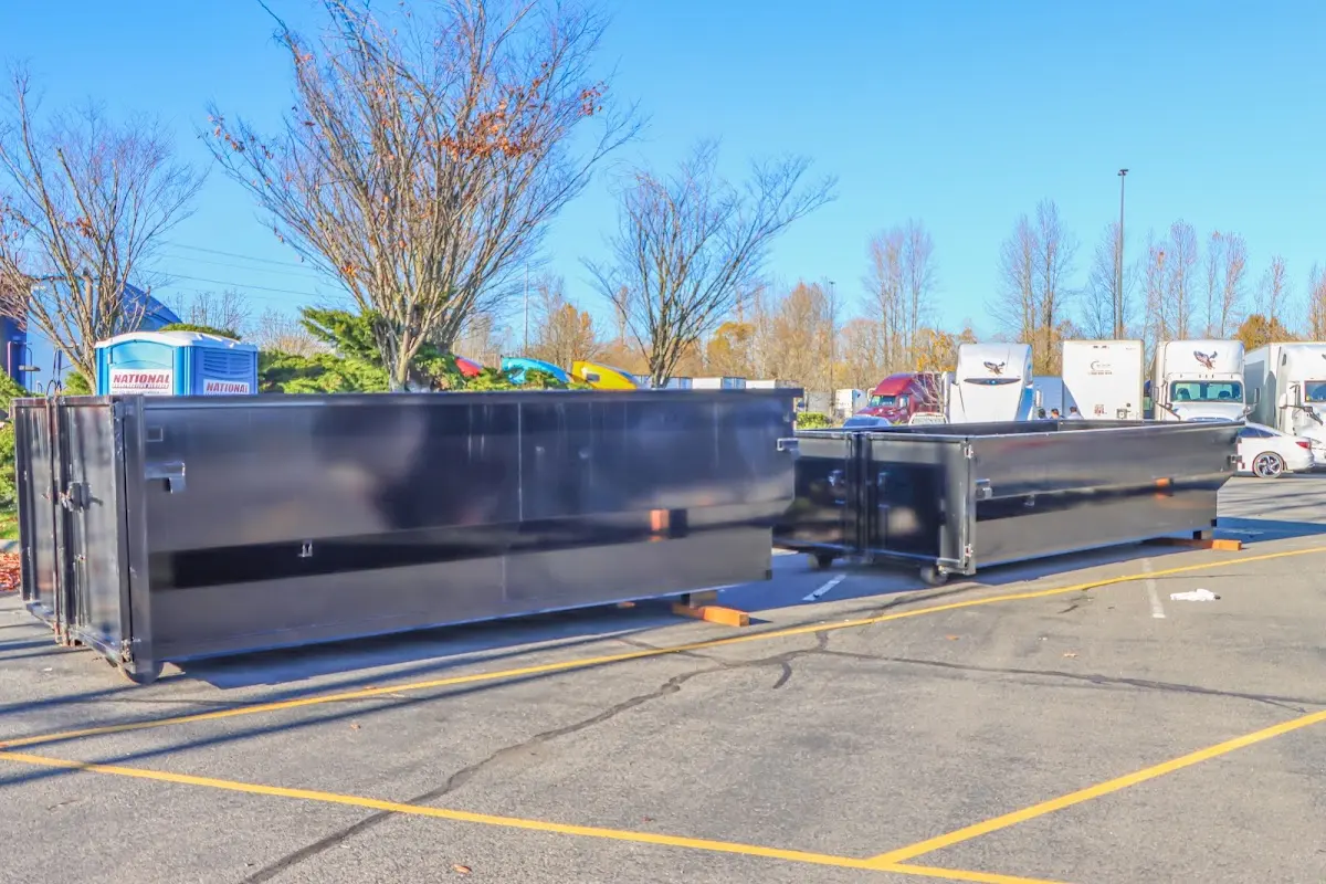 Professional dumpster rental service with roll-off container on residential driveway in Buckhead